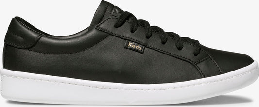 A black leather low-top sneaker with white sole.