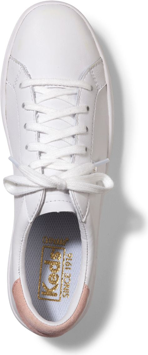 Top view of a white shoe with white laces and a pink heel.