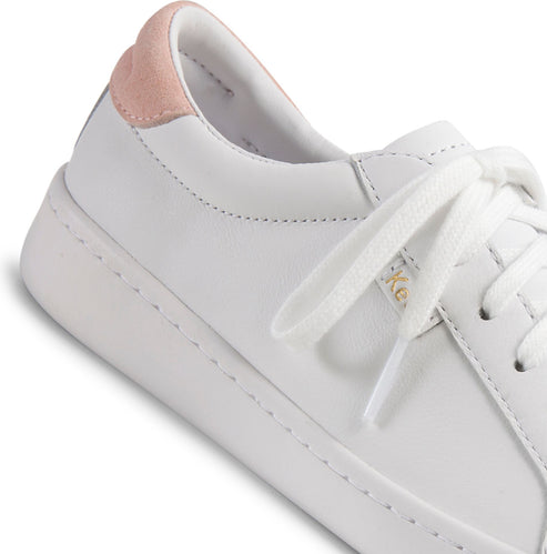 White leather sneaker with white laces and a pink heel.
