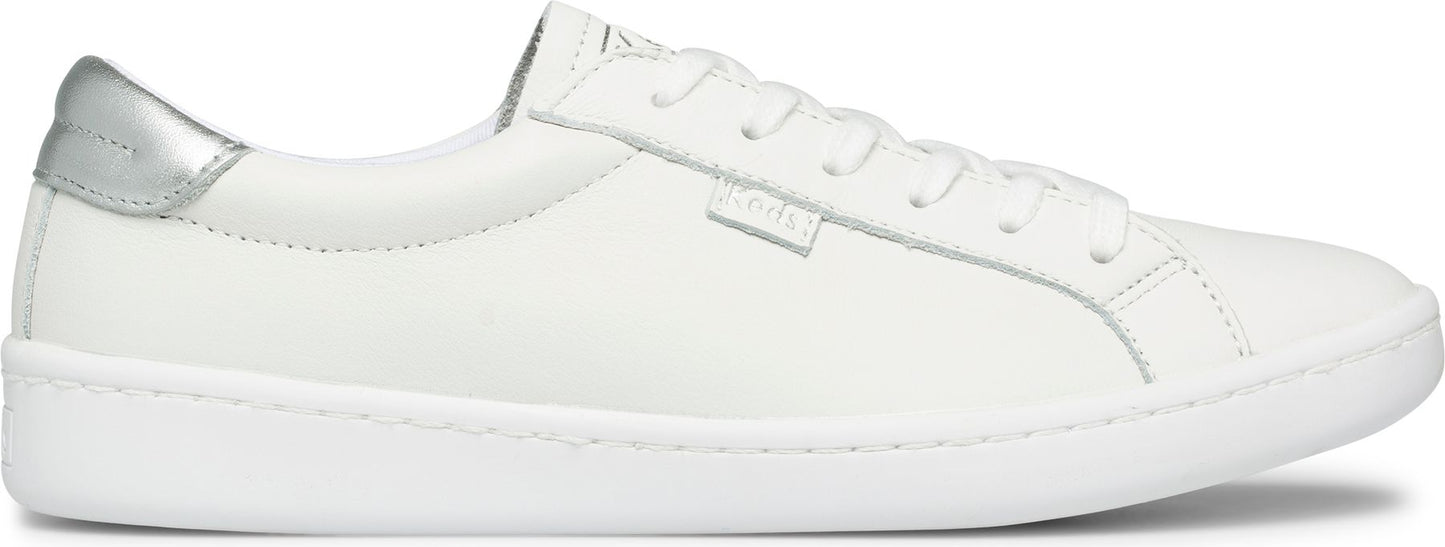 A white sneaker with white laces and a silver heel.