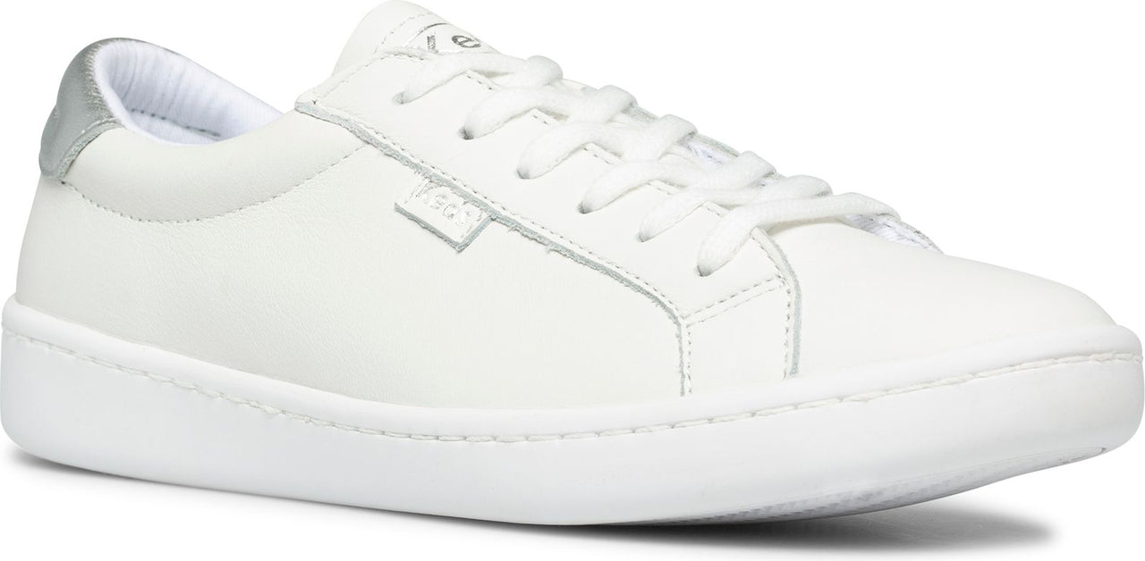 A white sneaker with white laces and a silver heel.