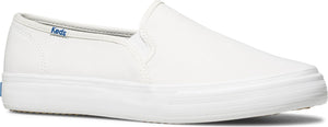 White slip-on shoe with a flat sole and Keds logo on the side.