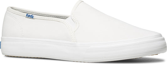 White slip-on shoe with a flat sole and Keds logo on the side.