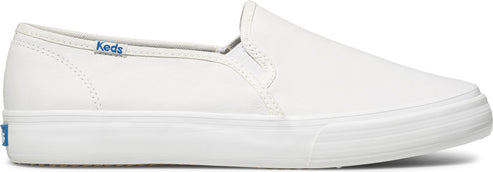 A white slip-on shoe with the Keds logo on the side.