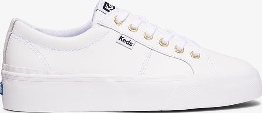 A white sneaker with gold eyelets.