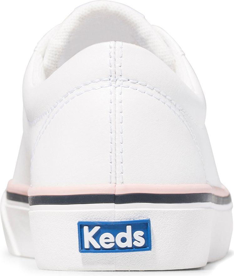 Rear view of a white shoe featuring a blue "Keds" logo on the heel, a white upper, and a pink and navy stripe detail.