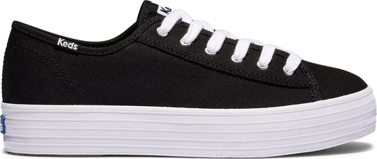 A black canvas sneaker with a thick white sole and white laces. The word "Keds" is visible on the side of the sneaker.