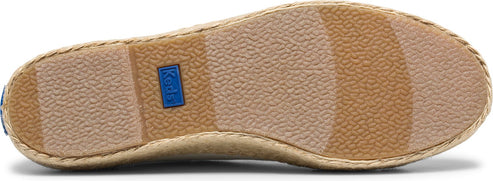 The sole of a shoe with textured treads and a label.