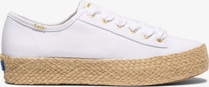 A white Keds sneaker with a woven sole.