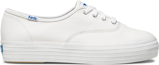 A white sneaker with laces and a ribbed sole. "Keds" is visible on the side.