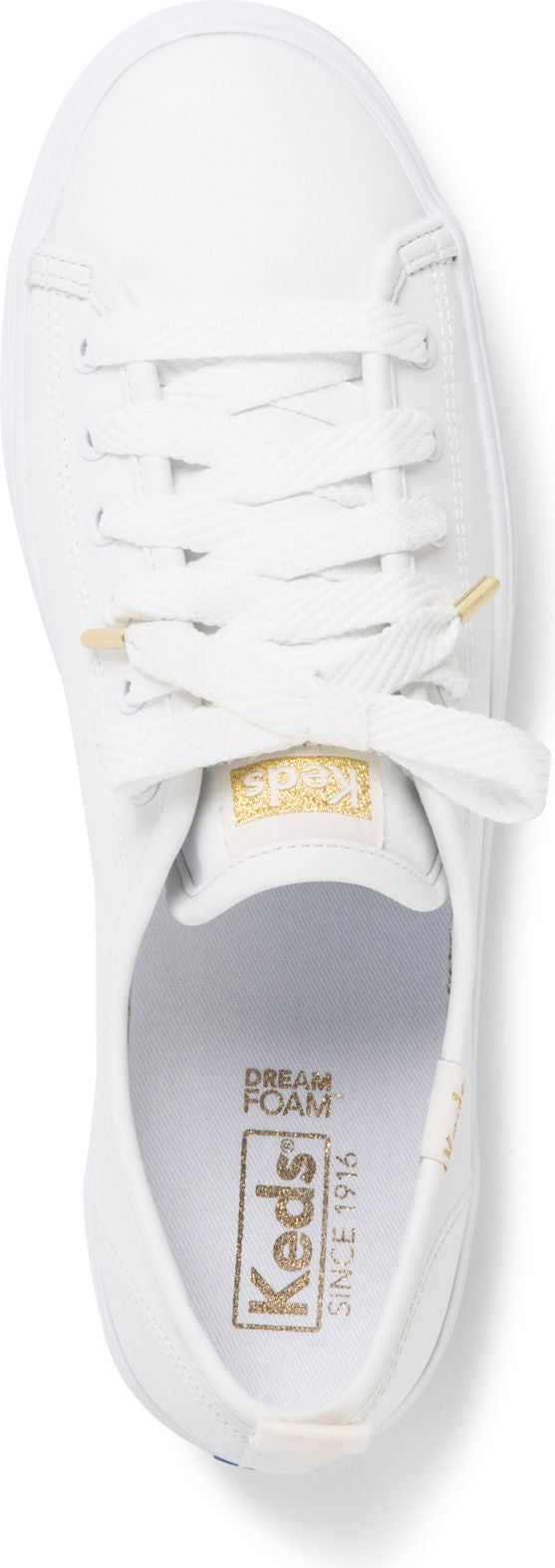A white sneaker featuring white laces, with the words "DREAM FOAM" and "Keds SINCE 1916" printed in gold.