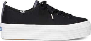 Black sneakers with laces and a white platform sole. The name "Keds" is visible on the side.