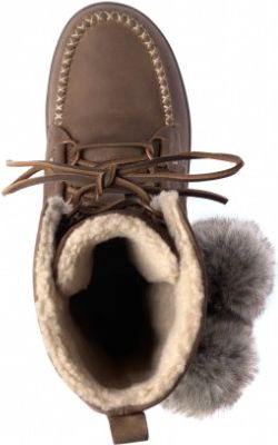 Eye-level view of brown, fur-lined moccasin boot with lace-up closure and gray fur pom poms.