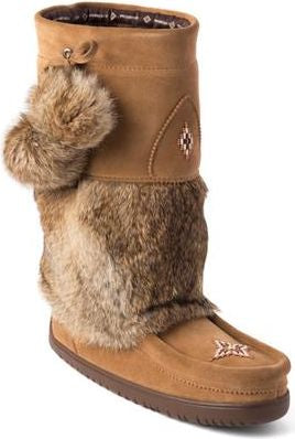 Tan suede moccasin boot with fur trim and pom poms.