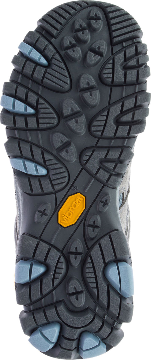 The sole of a shoe with various treads and a yellow logo in the center.