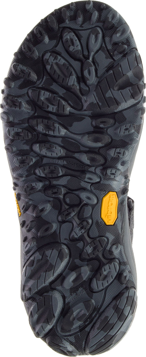 Black shoe sole with thick, patterned treads and a yellow logo.