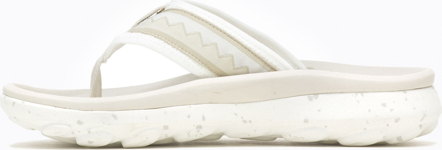 A white sandal with a thick, speckled sole.