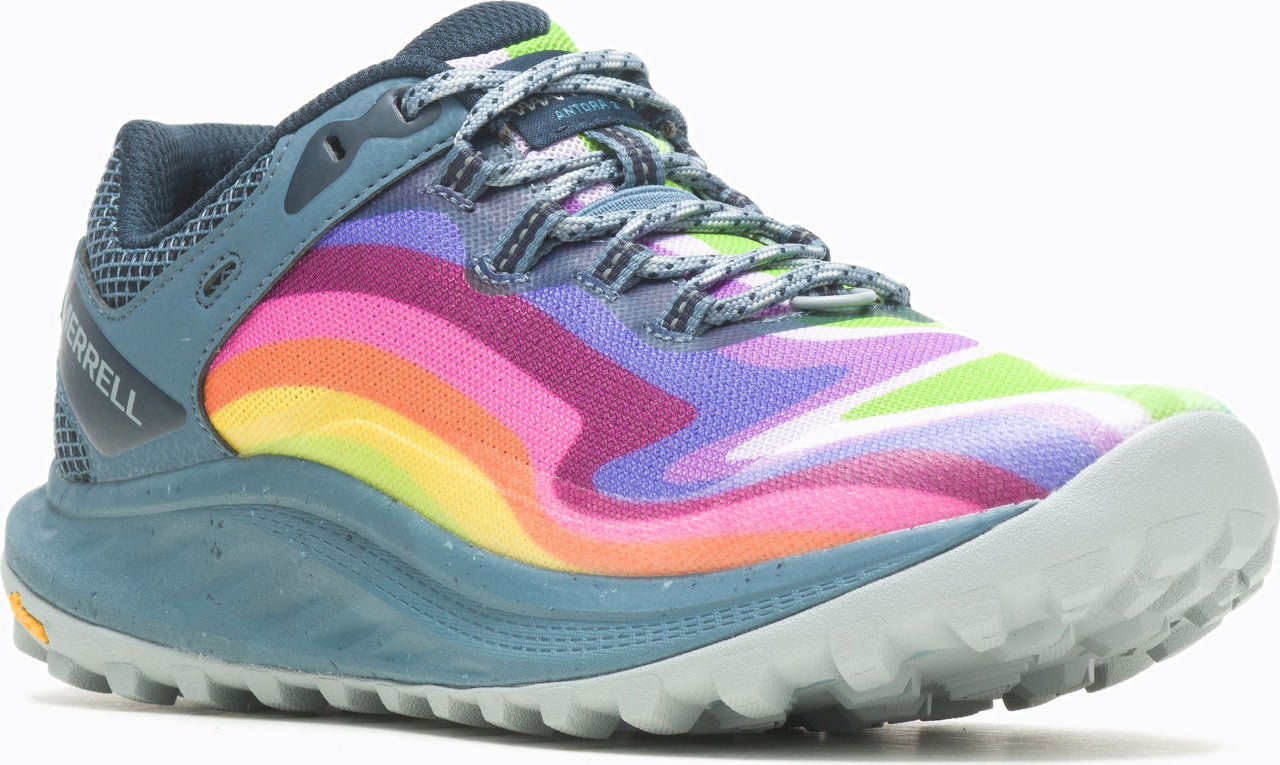 Close-up of a running shoe with a rainbow striped upper, gray laces, a blue heel and a gray sole.