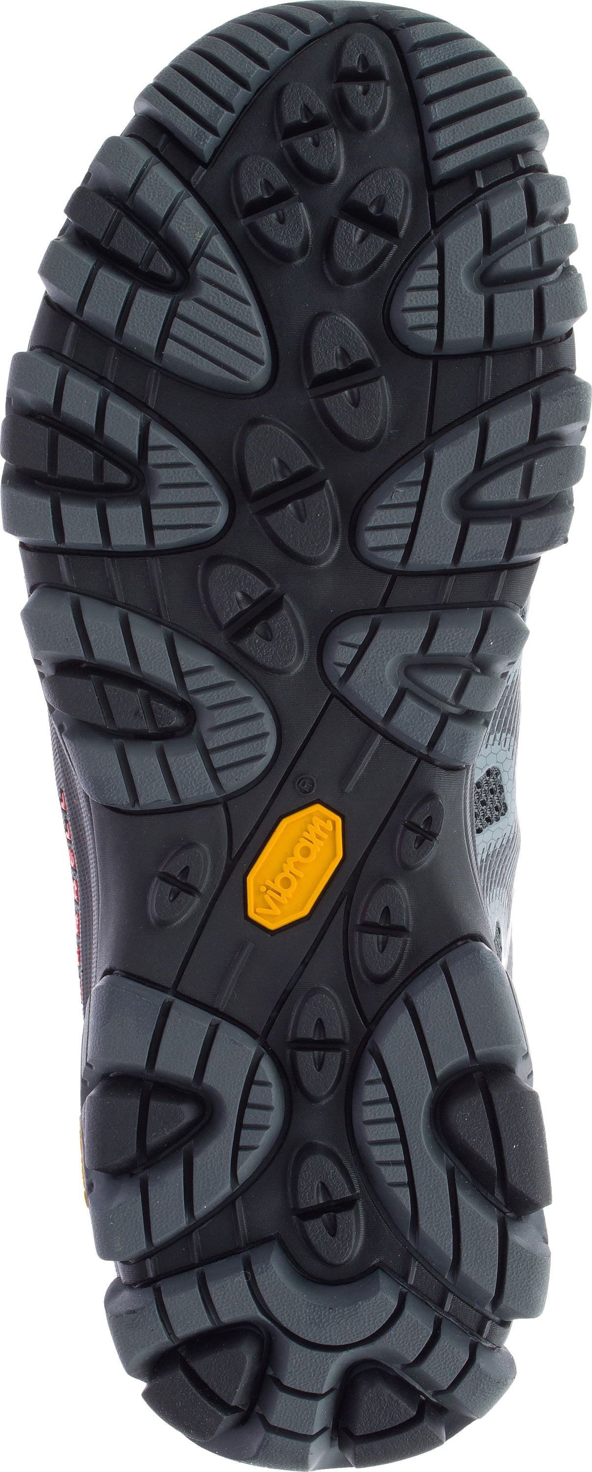 The sole of a shoe with black and gray treads and a yellow Vibram logo.