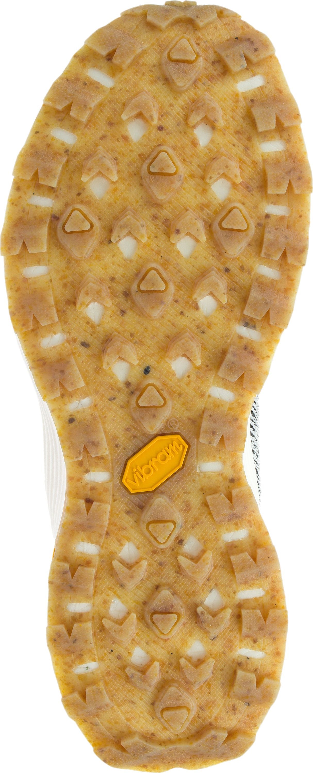 sole of a shoe with tan rubber and triangular treads; yellow vibram logo