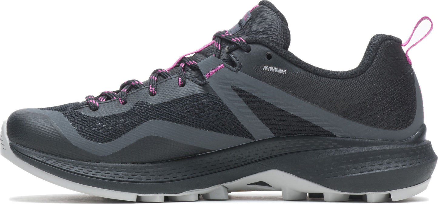 A dark colored trail running shoe with pink accents.
