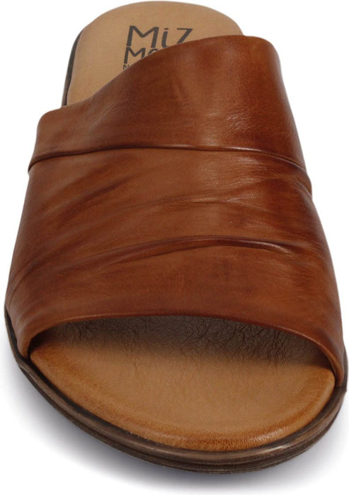 Front view of a brown leather sandal with a slip-on style and flat sole.