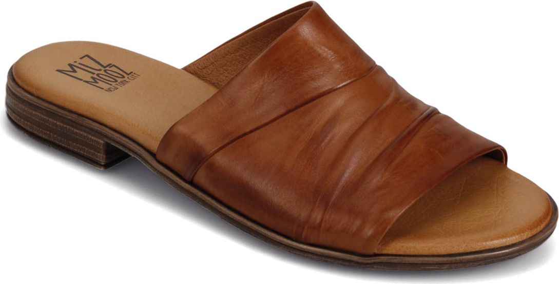 A light brown leather sandal with a low heel and a gathered band across the top.