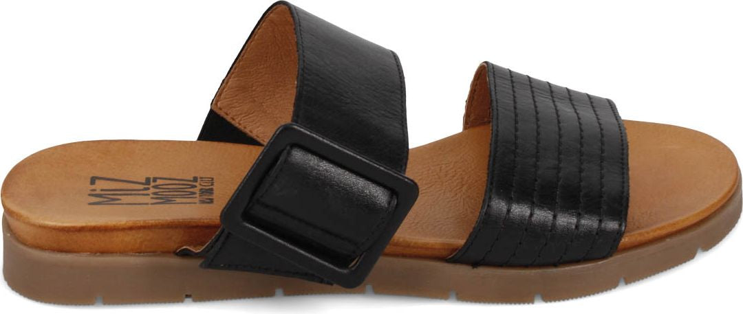A pair of slide sandals in black, each with a wide strap. One has a large square buckle.