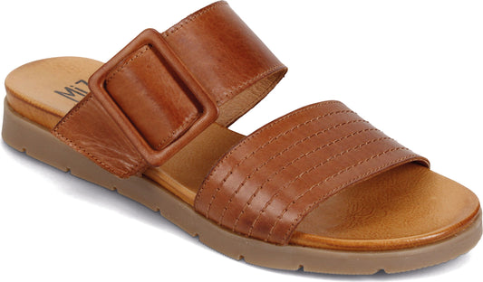 Tan slide sandal with two straps, one with a large square buckle.