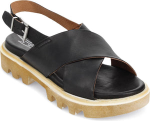 Black leather sandals with adjustable strap, a wide leather vamp, cross-over design, and thick lug soles.