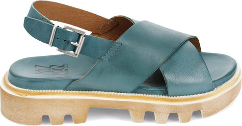 Turquoise leather sandal with thick treaded sole and adjustable ankle strap.