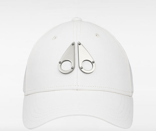 White cap with two metal, teardrop-shaped decorations on the front.