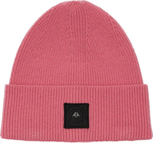Close-up of a pink ribbed knit beanie with a black square patch.