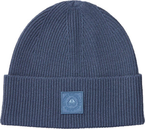 Close-up of a blue ribbed knit beanie with a blue patch near the brim featuring a logo.