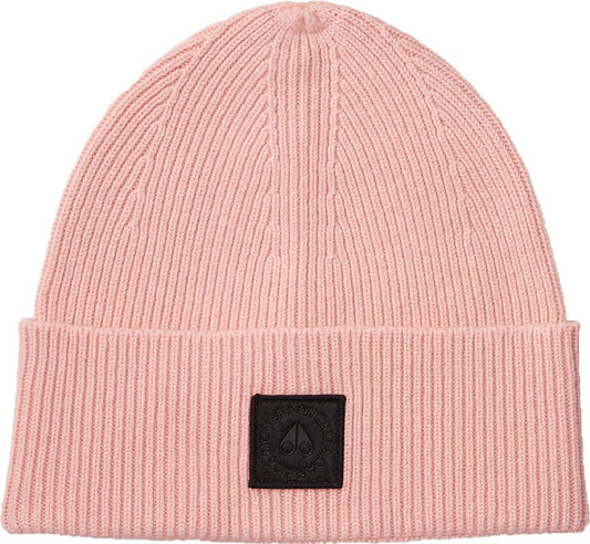 Pink beanie with vertical ribbed texture and a square black patch near the bottom.