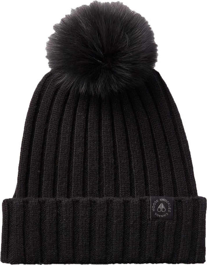 Black ribbed knit beanie with a black pompom on top and a dark patch on the turned up brim.