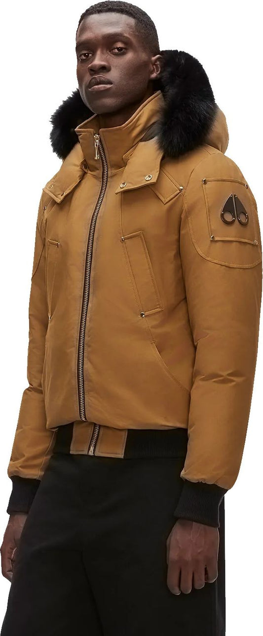 A tan bomber jacket with a black fur collar and cuffs.