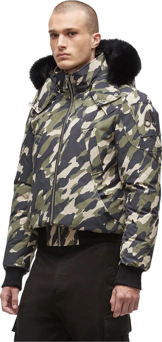 A man wearing a camouflage puffer jacket with fur hood.