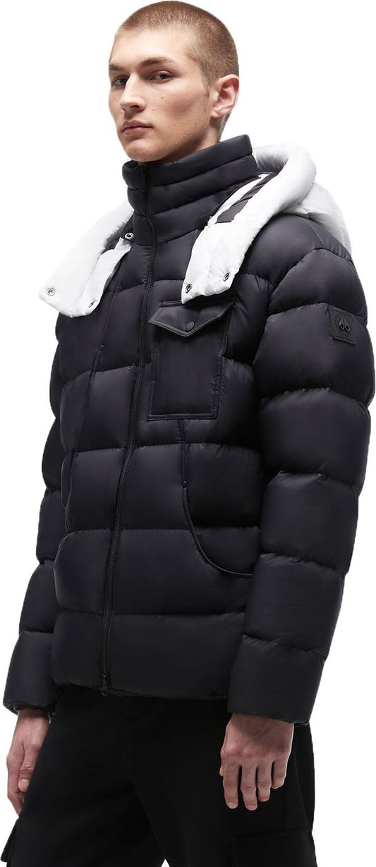 A man wearing a black puffer jacket with a white hood.