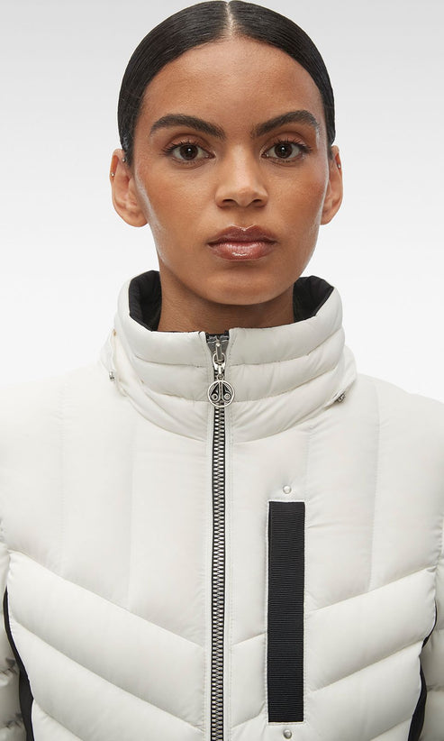 Woman in white quilted puffer jacket with black stripe.
