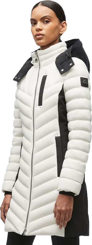 A woman wearing a black and white puffer coat.