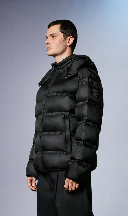 A man in a black puffer jacket with a hood.