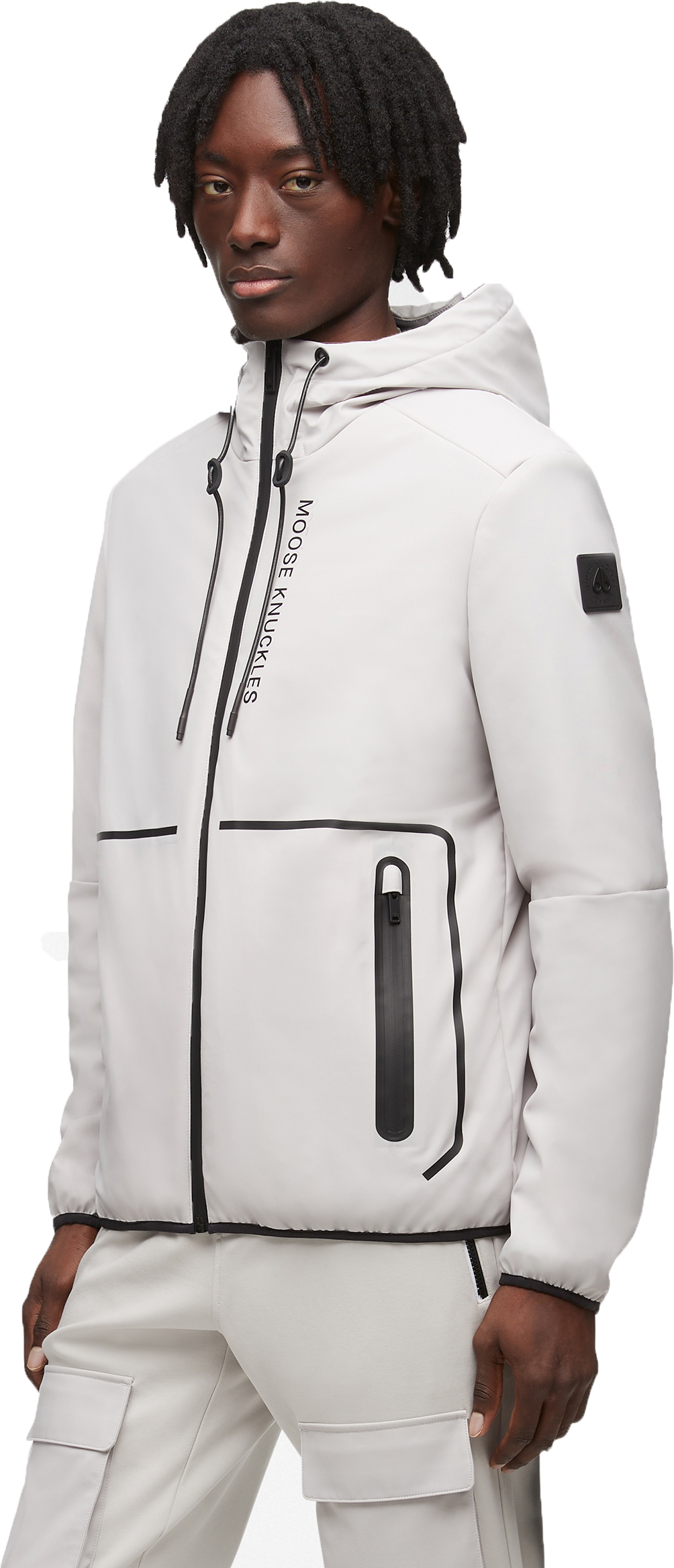 A person wearing a light gray hooded jacket with black zippers and detailing.