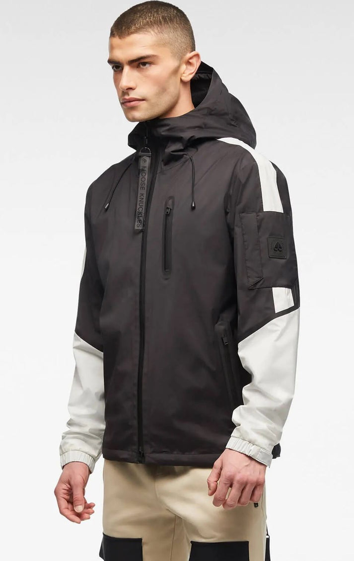Man in black and white windbreaker jacket with hood.