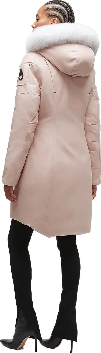 A pale pink winter parka with a white fur-trimmed hood is paired with black over-the-knee stiletto boots.