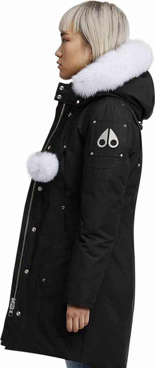 Black parka coat with white fur hood and white pompom accent.