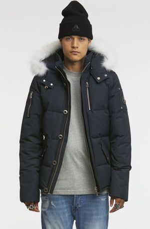 Person in a blue puffer jacket with a fur-trimmed hood and a black beanie.