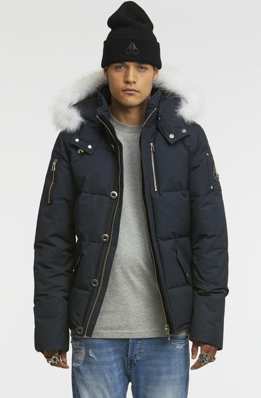 Person in a blue puffer jacket with a fur-trimmed hood and a black beanie.
