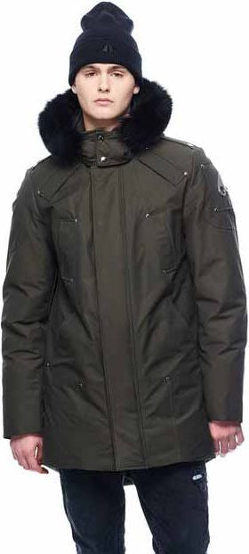 A person wearing a dark green parka with a fur-trimmed hood and a black beanie.