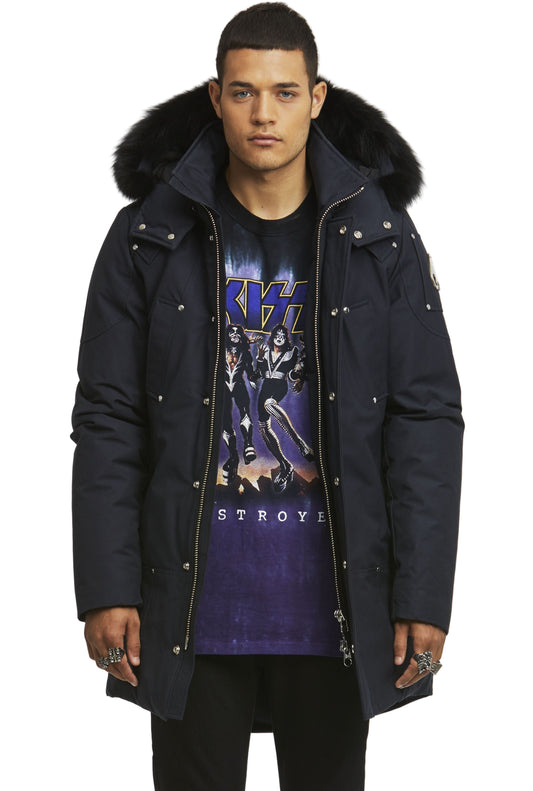Person wearing a dark blue parka with a fur-lined hood and a black T-shirt with the band KISS on it.